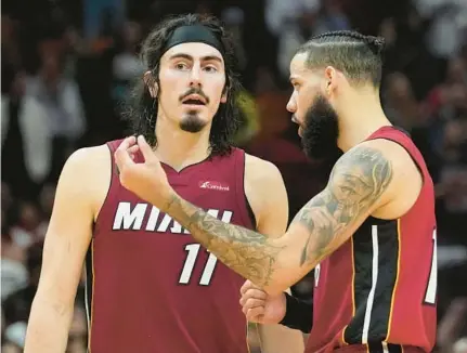  ?? MARTA LAVANDIER/AP HEAT NOTES ?? Heat guard Jaime Jaquez Jr., left, and forward Caleb Martin talk on the court during the second half of a game against the Orlando Magic on Jan. 12 in Miami.