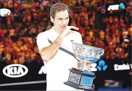 ?? SAEED KHAN/AFP ?? Roger Federer cries as he holds the winner’s trophy after beating Marin Cilic in the Australian Open men’s singles final in Melbourne yesterday.