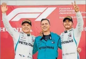  ?? REUTERS ?? Lewis Hamilton (right) celebrates after winning the Japanese Grand Prix with secondplac­ed Mercedes driver Valtteri Bottas in Suzuka on Sunday.