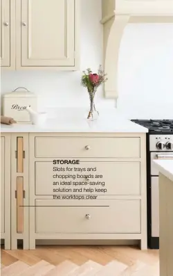  ??  ?? STORAGE
Slots for trays and chopping boards are an ideal space-saving solution and help keep the worktops clear