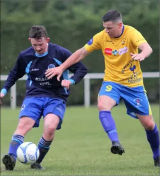  ??  ?? North End’s Jason Murphy closes in on Kevin Parker of Campile United.