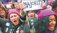  ?? JOHN MINCHILLO / AP ?? Protesters cheer at the Women’s March on Washington during the first full day of Donald Trump’s presidency on Saturday.