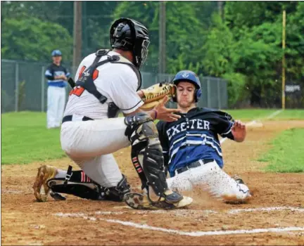  ?? THOMAS NASH - DIGITAL FIRST MEDIA ?? Exeter’s Andrew Barlow (3) slides in ahead of the tag from Daniel Boone catcher Victor Gonzalez to steal home during Saturday’s game. Exeter beat the Orioles, 12-4.