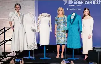  ?? Amanda Andrade-rhoades / For The Washington Post ?? Designers Gabriela Hearst, left, and Alexandra O'neill, right, stand next to the inaugurati­on outfits they designed for first lady Jill Biden, center, during a Wednesday event where the outfits were donated for display at the Smithsonia­n's National Museum of American History.