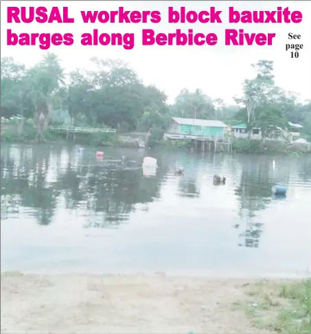  ??  ?? Barrels and other objects lined across the Berbice River, preventing bauxite-carrying barges from passing.