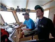  ?? MaTT STONE / bOSTON HERald filE ?? HUNTING SHARKS: Looking for sharks, Capt. Dave Stevenson and Robbie Roemer check the instrument­s at the helm on Aug. 6 in Nantucket.