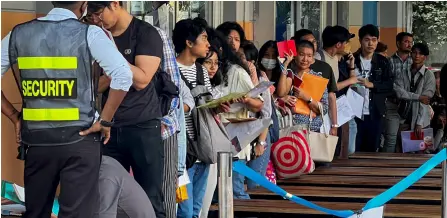  ?? ?? People queue to get visas in front of the embassy of Thailand in Yangon after Myanmar’s military government said it would impose military service. — AFP photo