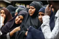  ?? AP/BRIAN INGANGA ?? Family members prepare to pray Wednesday over the bodies of two men killed in Tuesday’s attack in Nairobi, Kenya.