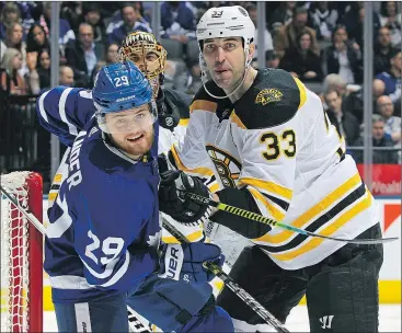  ?? — GETTY IMAGES ?? Bruins defenceman Zdeno Chara (right) tries to clear Maple Leafs forward William Nylander from in front of Boston’s net on Saturday night in Toronto. Chara finished the game with an assist and a plus-1 rating.