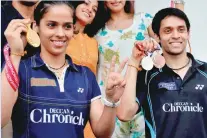  ?? — AFP ?? Saina Nehwal and Parupalli Kashyap.