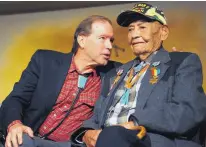  ?? ADOLPHE PIERRE-LOUIS/JOURNAL ?? U.S. Sen. Tom Udall chats with World War II veteran Wilson Halona of Tohatchi after presenting Halona with five medals during a ceremony in November 2012.