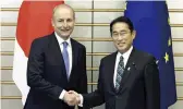  ?? The Yomiuri Shimbun ?? Prime Minister Fumio Kishida, right, shakes hands with Irish Taoiseach (prime minister) Micheal Martin at the Prime Minister’s Office in Tokyo on July 20.