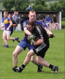  ??  ?? Carnew’s John Walshe challenges Newtown’s Cathal McNicholas.