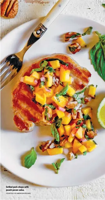  ?? COURTESY OF AMERICAN PECANS ?? Grilled pork chops with peach pecan salsa.