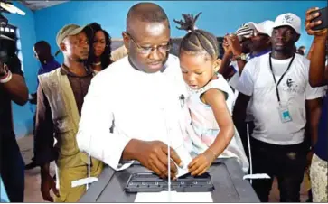  ?? ISSOUF SANOGO/AFP ?? Sierra Leone People’s Party presidenti­al candidate former General Julius Maada Bio casts his ballot at the polling station in Freetown on March 31 during Sierra Leone presidenti­al run-off. Bio was sworn in as the country’s president Wednesday night.