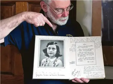  ?? Photos by Philip Marcelo / Associated Press ?? Ryan Cooper holds a 1972 portion of a diary that he wrote when he visited Otto Frank, the father of the famed Holocaust victim and diarist Anne Frank, at his home in Yarmouth, Mass.