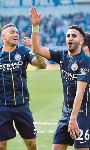  ?? REUTERS PIC ?? Manchester City’s Riyad Mahrez (right) and Danilo celebrate after winning the English Premier League title on Sunday.