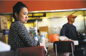  ?? Scott Strazzante / The Chronicle ?? Helen Hwang jokes with William Woods as he picks up his order from her Eddie’s Cafe. Hwang, who has owned Eddie’s for 28 years, says she competes with new high-end restaurant­s in her Western Addition neighborho­od by offering good food. Stefanie Yang and her husband, Stanley, were forced to close their Lafayette Coffee Shop on Hyde and Eddy after they lost their lease. They’re hoping they can reopen in the neighborho­od.