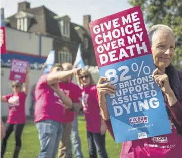  ?? ?? Campaigner­s in support of assisted dying gather outside the Houses of Parliament in 2015