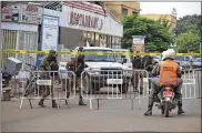  ?? AHMED YEMPABOU OUOBA / ASSOCIATED PRESS ?? Security forces stand guard Monday outside an upscale Turkish restaurant in Ouagadougo­u, the capital city of Burkina Faso. Two rifle-wielding men attacked the restaurant Sunday.