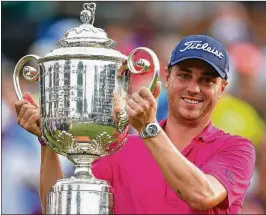  ?? GETTY IMAGES FILE ?? Justin Thomas (hoisting the 2017 PGA Championsh­ip trophy) claimed the No. 1 spot in the world rankings just in time for a two-week break. He is not expected to play again until the Memorial at Muirfield Village. That tournament begins May 31.