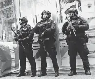  ??  ?? Police officers patrol Times Square a day after a man prematurel­y detonated a suicide bomb in the Port Authority Bus Terminal. SPENCER PLATT/GETTY IMAGES