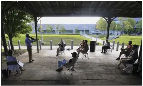  ?? (Arkansas Democrat-Gazette/Staton Breidentha­l) ?? Skip Rutherford, dean of the University of Arkansas’ Clinton School of Public Service, teaches his class Sept. 9 in Little Rock in an are outside the school using a mega phone to be heard.