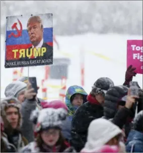  ?? PHOTO BY DANNY MOLOSHOK — INVISION — AP ?? A demonstrat­or holds a sign related to U.S. President Donald Trump and Russia at the Respect Rally Park City during the 2018 Sundance Film Festival on Saturday in Park City, Utah.