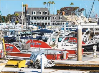  ?? DON BOOMER ?? Oceanside harbor police boats sit idle at the dock near their headquarte­rs along North Harbor Drive on Wednesday. There is a proposal to change the way marine safety services operate at the harbor.