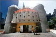  ?? MARK LENNIHAN ?? In this Aug. 10 file photo, a constructi­on worker walks in front of the St. Nicholas National Shrine in New York. Work on the Greek Orthodox church destroyed in the Sept. 11 attacks next to the World Trade Center memorial plaza has been temporaril­y...