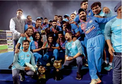  ?? AP ?? India’s team members pose with the Nidahas Trophy after beating Bangladesh in the T20 tri-series final in Colombo. —