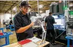  ?? CONTRIBUTE­D BY ELISSA BENZIE ?? Phillip Murray works on a prototype at Plethora, whose goal is to make manufactur­ing more accessible.