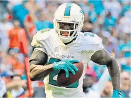  ?? CHARLES TRAINOR JR/MIAMI HERALD ?? Miami Dolphins defensive back Reshad Jones returned a fumble for a touchdown against the Tennessee Titans at Hard Rock Stadium last week.