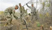  ?? CAITLIN O’HARA WASHINGTON POST ?? National Guardsmen clear brush near the Andrade Port of Entry in California. The Guard’s work on the border is done mostly in the background since they’re barred from law enforcemen­t duties.