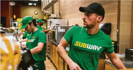  ?? Sam Hodgson / New York Times ?? Jeffrey Kaplow works behind the counter at his Subway store in New York. Kaplow is trying to find more employees.