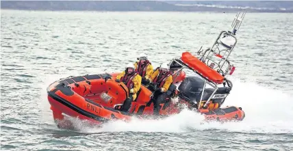  ??  ?? ● On September 8, volunteer crew members from Criccieth’s RNLI Lifeboat station rescued a kite-surfer after coming across him and his kite by chance. The Station’s Atlantic 85 Lifeboat, Doris Joan, had launched into heavy seas earlier in the evening...