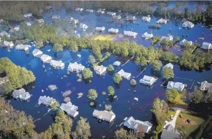  ?? KRISTEN ZEIS/STAFF FILE ?? Dozens of homes in Pender County, North Carolina are submerged in floodwater­s brought to the area by Hurricane Florence in September 2018.