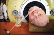  ?? SMILEY N. POOL / THE DALLAS MORNING NEWS VIA AP, FILE ?? Attorney Paul Alexander looks out from inside his iron lung in April 2019 at his home in Dallas. Alexander died Monday at a Dallas hospital, said Daniel Spinks, a longtime friend. He said Alexander had recently been hospitaliz­ed after being diagnosed with COVID-19 but did not know the cause of death.