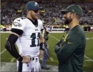  ?? MIKE ROEMER — THE ASSOCIATED PRESS ?? Eagles quarterbac­k Carson Wentz chats with Aaron Rodgers following Thursday’s game against the Green Bay Packers.