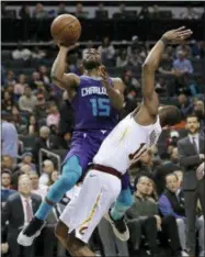  ?? CHUCK BURTON — ASSOCIATED PRESS ?? Hornets guard Kemba Walker (15) drives against Cavaliers guard Alec Burks (10) during the second half in Charlotte, N.C., Dec. 19.