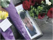  ??  ?? A photograph of policeman Keith Palmer, who was killed in the Westminste­r terror attack, is placed in central London on Thursday. Channel 4 News had to apologise for wrongly naming a suspect.