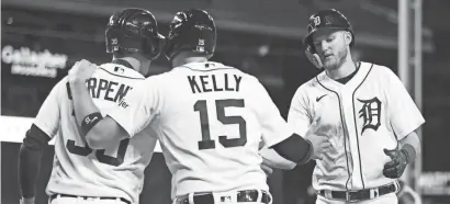  ?? GREGORY SHAMUS/GETTY IMAGES ?? Tigers center fielder Parker Meadows, right, celebrates scoring with catcher Carson Kelly and right fielder Kerry Carpenter in the sixth inning Tuesday at Comerica Park.