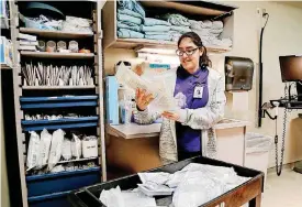  ?? [PHOTOS BY JIM BECKEL, THE OKLAHOMAN] ?? Jasmine Loyola, 18, is one of several Oklahoma City students with disabiliti­es taking part in an internship at Integris Southwest Medical Center to learn career skills.