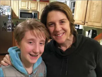  ?? CLARE SCHEXNYDER­VIA AP ?? Small business owner Clare Schexnyder, 49, poses with her daughter, Sofi, in their kitchen in Decatur, Ga., on Jan. 27, 2017. A breast cancer survivor, Schexnyder says she wouldn’t be alive if not for the Obamacare that paid for her mammograms, and...