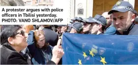  ?? ?? A protester argues with police officers in Tbilisi yesterday. PHOTO: VANO SHLAMOV/AFP