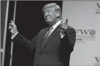  ?? The Associated Press ?? GESTURES: President Donald Trump gestures to music as he arrives to speak to the national convention of the Veterans of Foreign Wars, Tuesday in Kansas City, Mo.