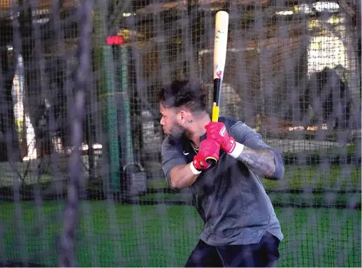  ?? MATT YORK/AP ?? Yoan Moncada takes some swings Wednesday after arriving early to Sox camp. He’ll leave the team in March to play in the World Baseball Classic.