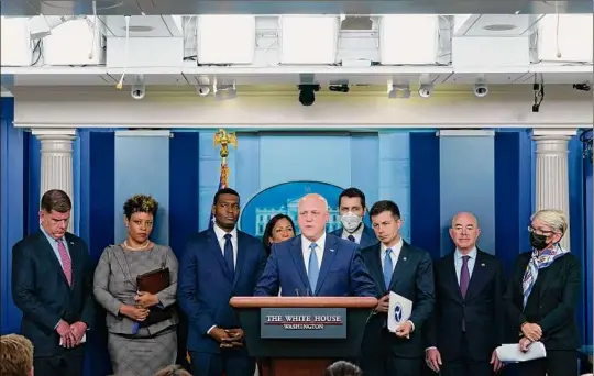  ?? Susan Walsh / Associated Press ?? White House infrastruc­ture coordinato­r Mitch Landrieu, center, speaks Monday during a briefing on the six-month anniversar­y of the law.