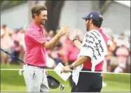  ?? Jamie Squire / Getty Images ?? Webb Simpson celebrates with his caddie Paul Tesori on the 18th green after winning The Players Championsh­ip on Sunday in Ponte Vedra Beach, Fla.