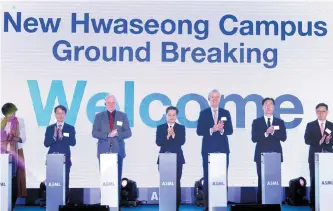  ?? Courtesy of ASML ?? ASML CEO Peter Wennink, third from right, Gyeonggi Province Governor Kim Dong-yeon, center, and other officials attend the groundbrea­king ceremony for ASML’s local repair and training facility in Hwaseong, Gyeonggi Province, Wednesday.